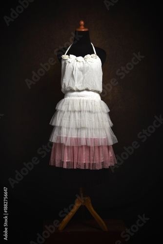Halter neck with ruffles white and pink dress on a display mannequin