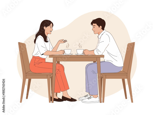 Couple sitting at table eating and chatting in restaurant or cafe setting