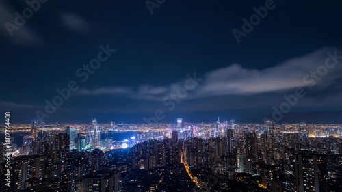 Wallpaper Mural Stunning Nighttime Cityscape with Illuminated Buildings and Moving Clouds. Torontodigital.ca