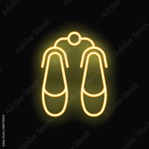 Yellow neon sign showing ballet shoes hanging on a rack against a dark background