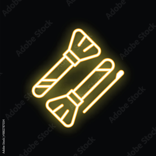 Yellow glowing neon sign representing makeup brushes and mascara, perfect for beauty salon or fashion industry