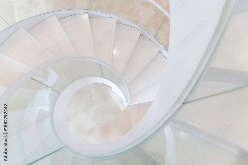 Fototapeta premium Beautiful white spiral staircase in the building