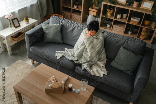 Obraz na plátně Woman shivering on sofa, feeling cold and ill at home