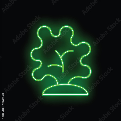 Green neon sign representing a small tree growing on a patch of land, on a black background