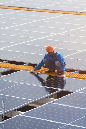 Technicians are installing outdoor solar panel systems. Solar rooftop installation. Solar panels on the roof. Workers are installing energy-saving solar power generation systems.	