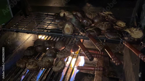 Wallpaper Mural Grilling skewered shiitake mushrooms using a gas grill in the night Torontodigital.ca