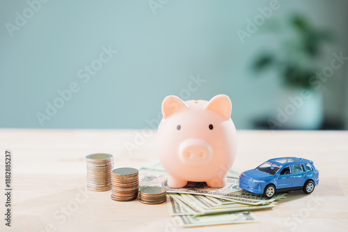 Piggy bank with car helps save money for auto insurance and fuel cost, refinance loan or finance drive and gas for transportation needs monthly budget planning with savings © sorapop