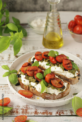 Italian sandwiches with grilled tomatoes, burrata cheese and pesto