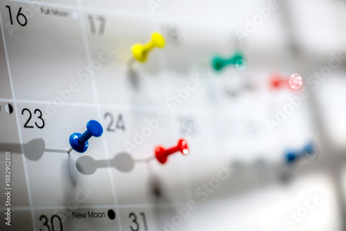 Calendar appointment thumbtacks in various dates on calendar diary