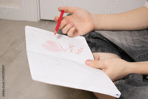 Wallpaper Mural A child's drawing, done in red crayon on white notebook paper. The word "love" is crossed out and replaced with "hate." Unrequited love for Valentine's Day. Torontodigital.ca