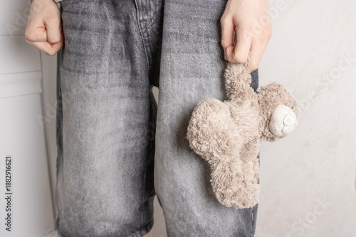 Wallpaper Mural A child in gray denim shorts holds a cute brown teddy bear. Torontodigital.ca