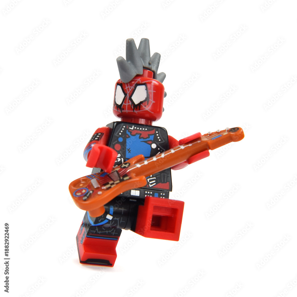 Fototapeta premium Lego minifigures of Spiderman is playing a guitar. Editorial illustrative image of popular children toys and movie Marvel.