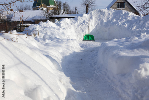 Wallpaper Mural Winter snow path with snow piles near a house and church dome in a small village Torontodigital.ca