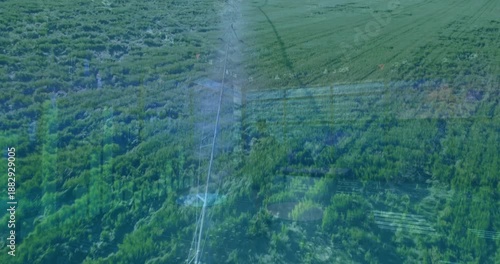 Animation of digital data and graphs overlaying lush green agricultural landscape