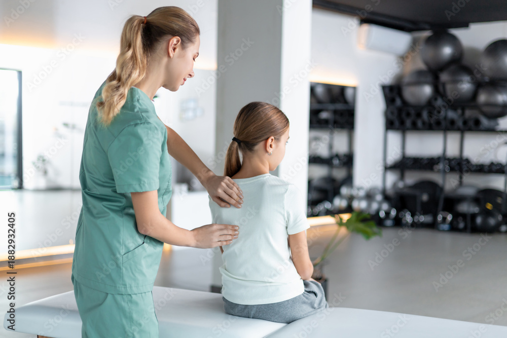 Fototapeta premium Woman therapist working with girl during rehab session