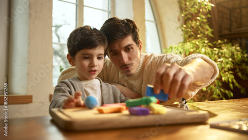 Father and son enjoying creative clay play during quality family time. Concept of work life balance, emotional bonding, childhood creativity, positive parenting and meaningful moments at home.
