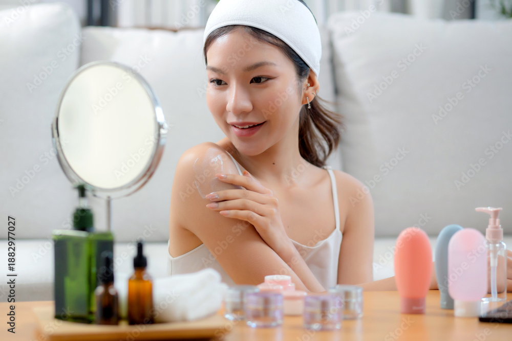 custom made wallpaper toronto digitalBeauty young asian woman applying cream or lotion while looking mirror in living room at home, happy beautiful woman applying skincare for rejuvenation on shoulder, skin care and health, self care.