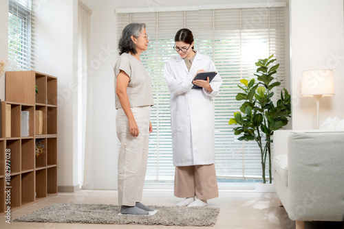 Wallpaper Mural Asian woman doctor checkup patient senior for medical health, nutritionist weighing scale with elderly while using tablet for health data recording in clinic office, consultation and diagnosis. Torontodigital.ca