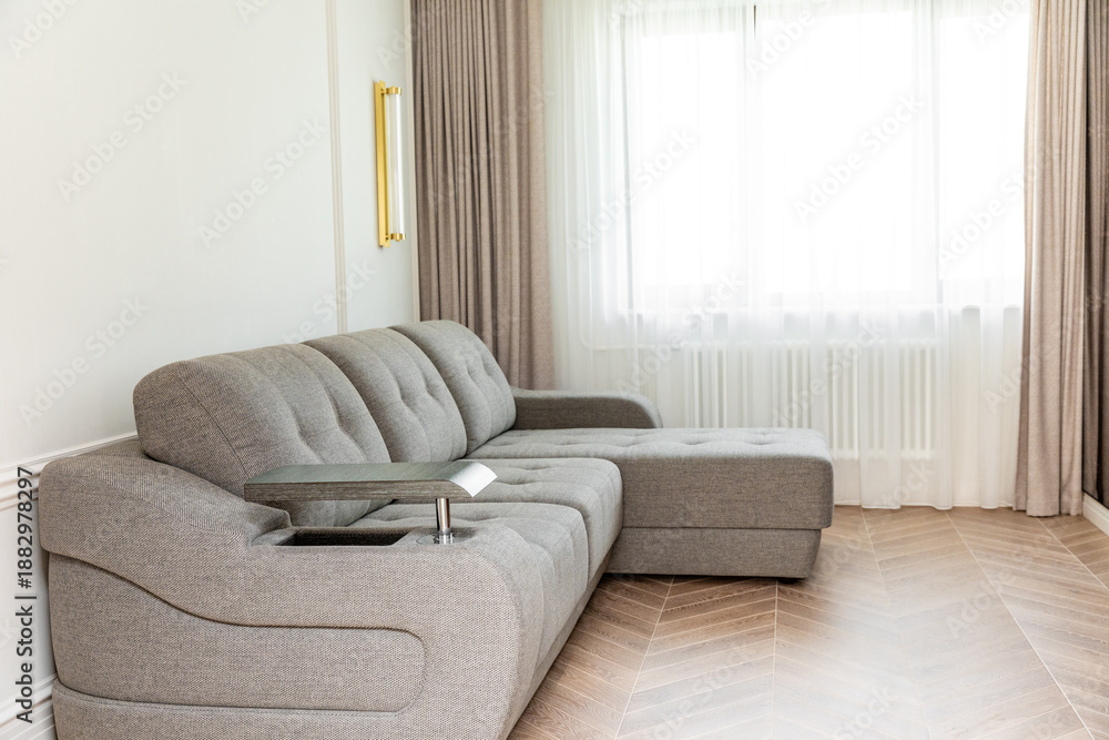 Foto Fashion furniture inside modern light living room with grey comfortable sofa, no people
