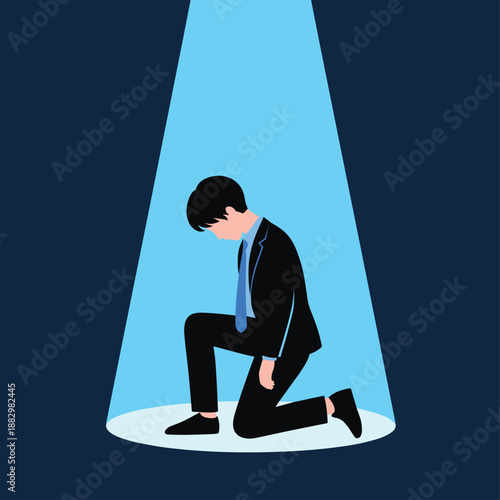 A businessman kneeling in a spotlight with his head bowed in a dark room Keywords: businessman, kneeling, spotlight, dark, room, despair, failure, shame, sadness, depression