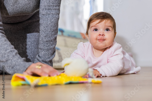Canvas Print Baby on floor playing with toy during tummy time