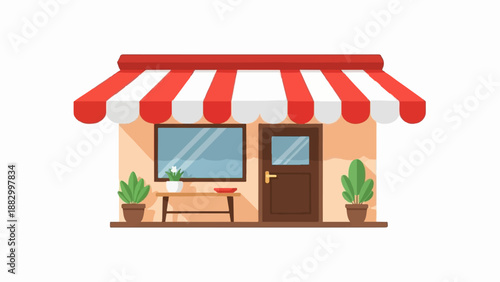 Storefront with striped awning, plants, and table