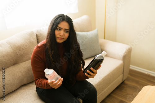 Φωτογραφία Woman making difficult healthy lifestyle choice between refreshing bottled water