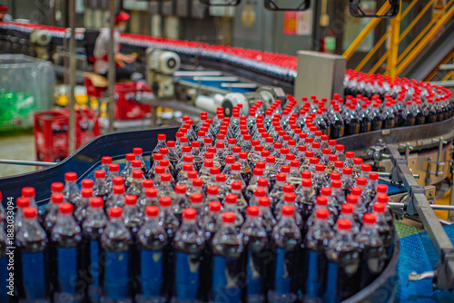 Beverage factory interior. Conveyor flowing with bottles for carbonated