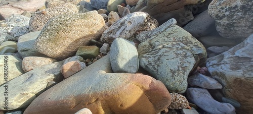 Natural beach rocks creating abstract stone texture background