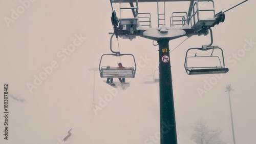 Chairlift in Foggy Snowy Mountains of Northern Italy