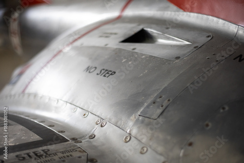 Aircraft metal skin showing warning message and rivets