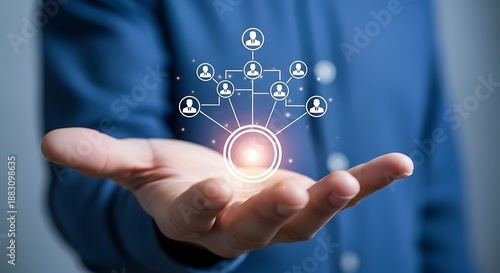 Businessman holding a glowing digital network diagram representing human resource management organizational structure and team connection concepts above his open palm