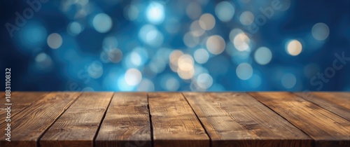 Wooden desk set against a blue background with blurred lights © The 2R Artificiality