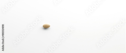 Bird's-eye shot of lone sesame seeds against a white backdrop