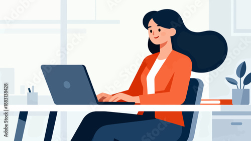 A woman is sitting at a desk with a laptop in front of her. She is smiling and she is enjoying her work