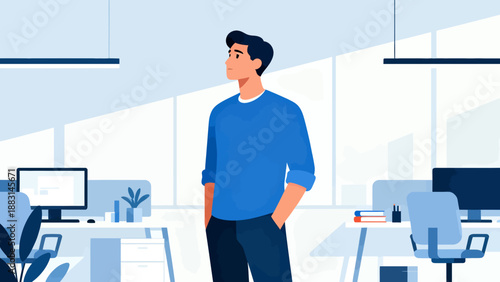 A man stands in a cubicle with a computer monitor in front of him. He is wearing a blue shirt and has his hands in his pockets. The cubicle is filled with office furniture, including a desk, a chair