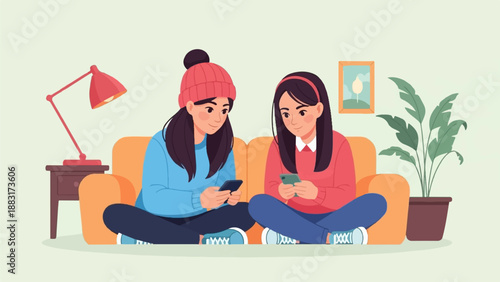 Two girls sit on a couch, engrossed in their phones, in a cozy room