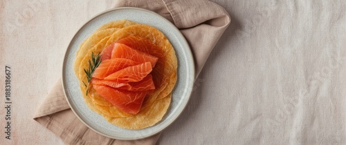 Salmon fillet slices on crepes from a top perspective