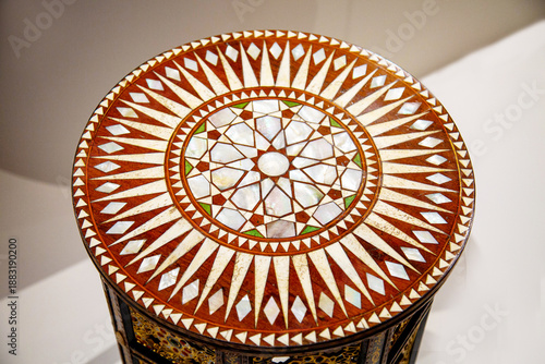 The table cover is round in shape with a beautiful wood pattern. Design, construction, textures.