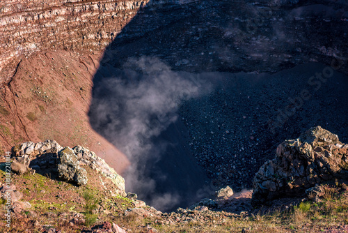 Mount Vesuvius volcano crater showing rocky terrain with active fumaroles releasing steam in Italy