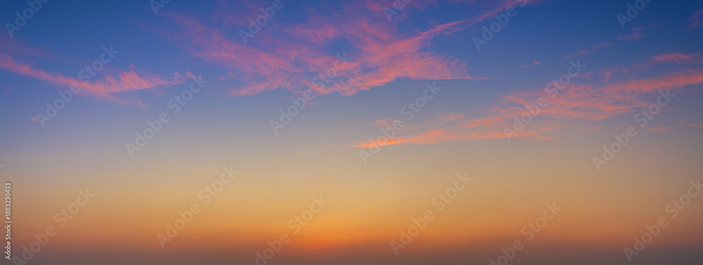 Fototapeta premium Colorful clouds and sky. Dusk and sunset. Evening clouds with orange, yellow, pink and red sunlight and amazing storm clouds in the dusk sky,Dramatic sunset sky with colorful clouds over city,