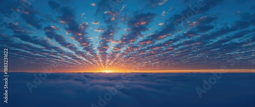 Colorful evening sky with dramatic blue clouds illuminated by sunset, showcasing a wide landscape