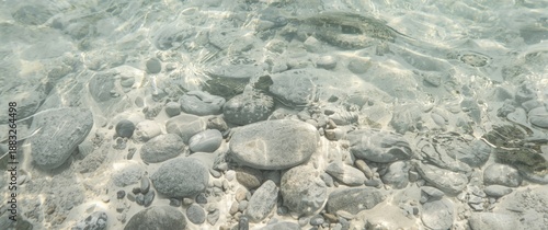 Pebble stones beneath clear...