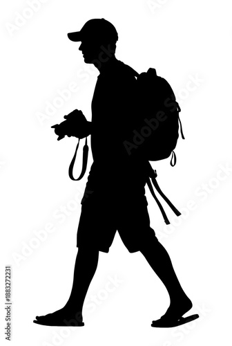 Silhouette of a photographer, carrying camera and backpack