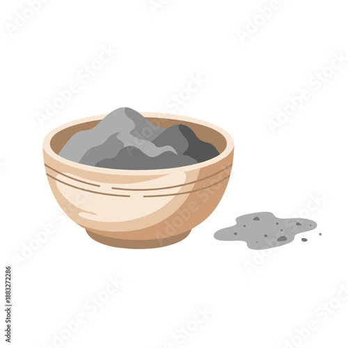A bowl of grey powder with spilled powder on the side. The scene focuses on the bowl and its contents