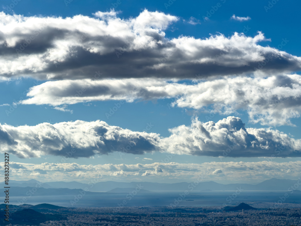 Obraz premium Dramatic cumulus cloud over the Athens basin, panoramic city view from Penteli mountain, Greece