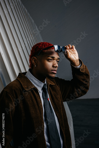 portrait of a black man taking off his sunglasses