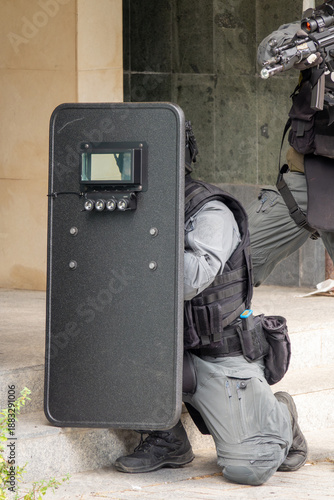 Wallpaper Mural Tactical Police Unit in Action with Ballistic Shield and Assault Rifle During Urban Operation. Armed SWAT Officers in Full Gear Performing in City Environment Torontodigital.ca