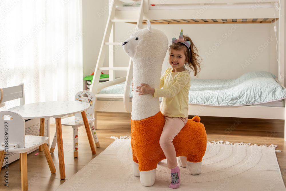 custom made wallpaper toronto digitalHappy Little Girl Riding Plush Llama Toy in Cozy Children?s Bedroom. Playful Childhood Moment, Imagination, and Joyful Home Lifestyle Concept