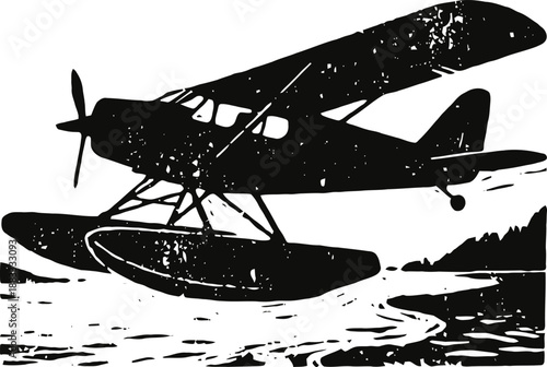 vintage floatplane flying low over water with forested shoreline in the background